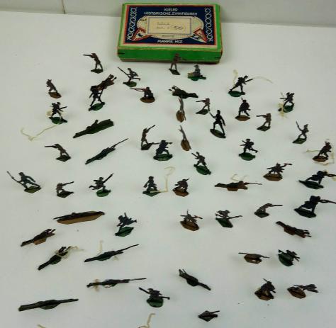 about 50 tinnie toy soldiers