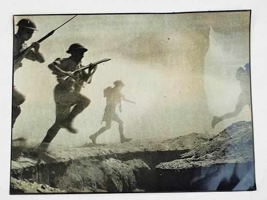 a british ww2 press picture off a group of soldiers attacking