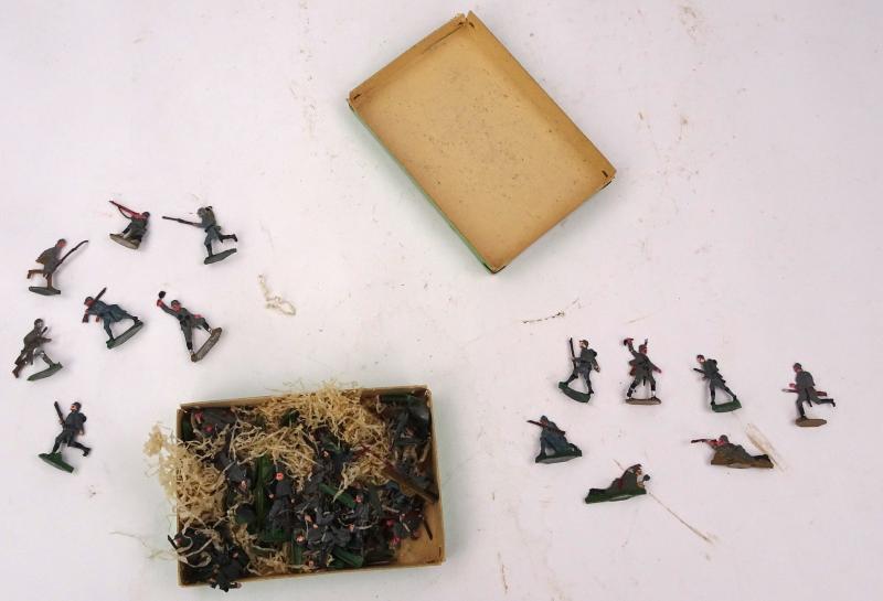 about 50 tinnie toy soldiers in nice Original box